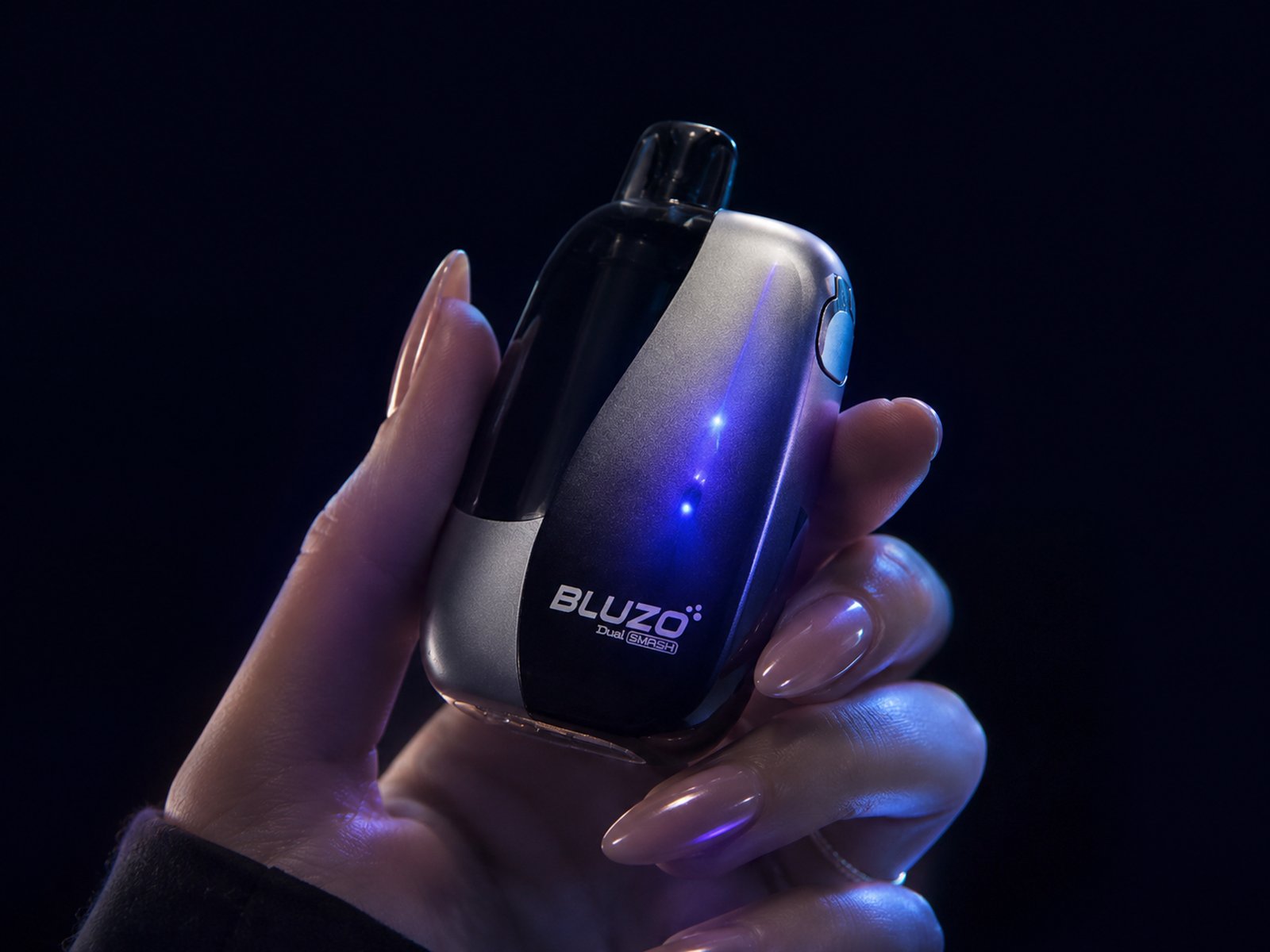 Device in hand, ready to use — lifestyle close-up, dark scene
